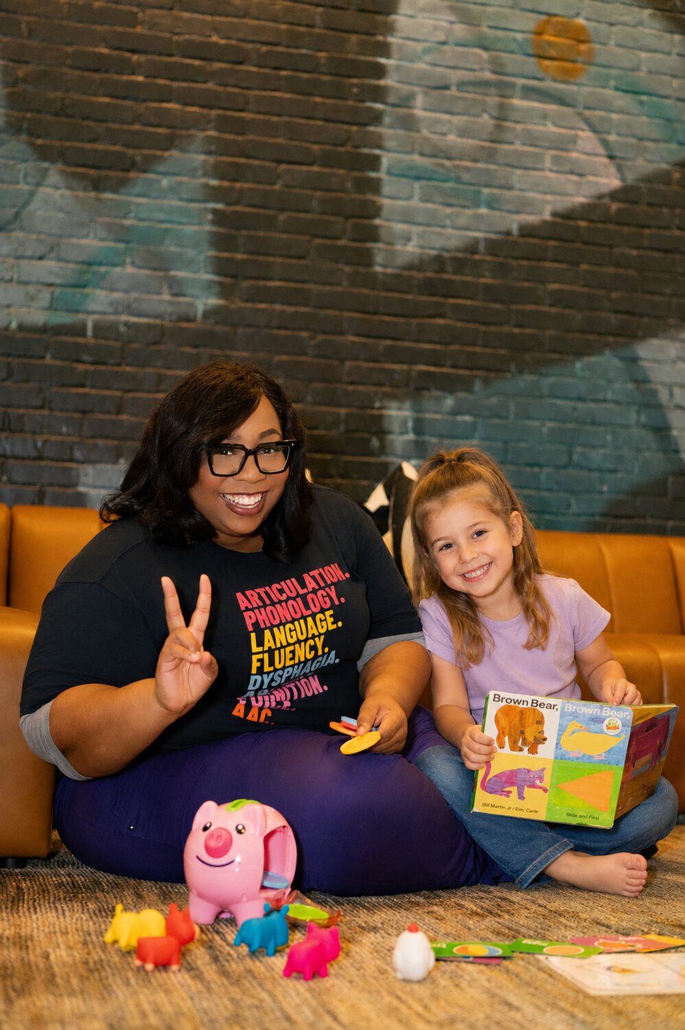 Olivia sharing a book and a smile with a child