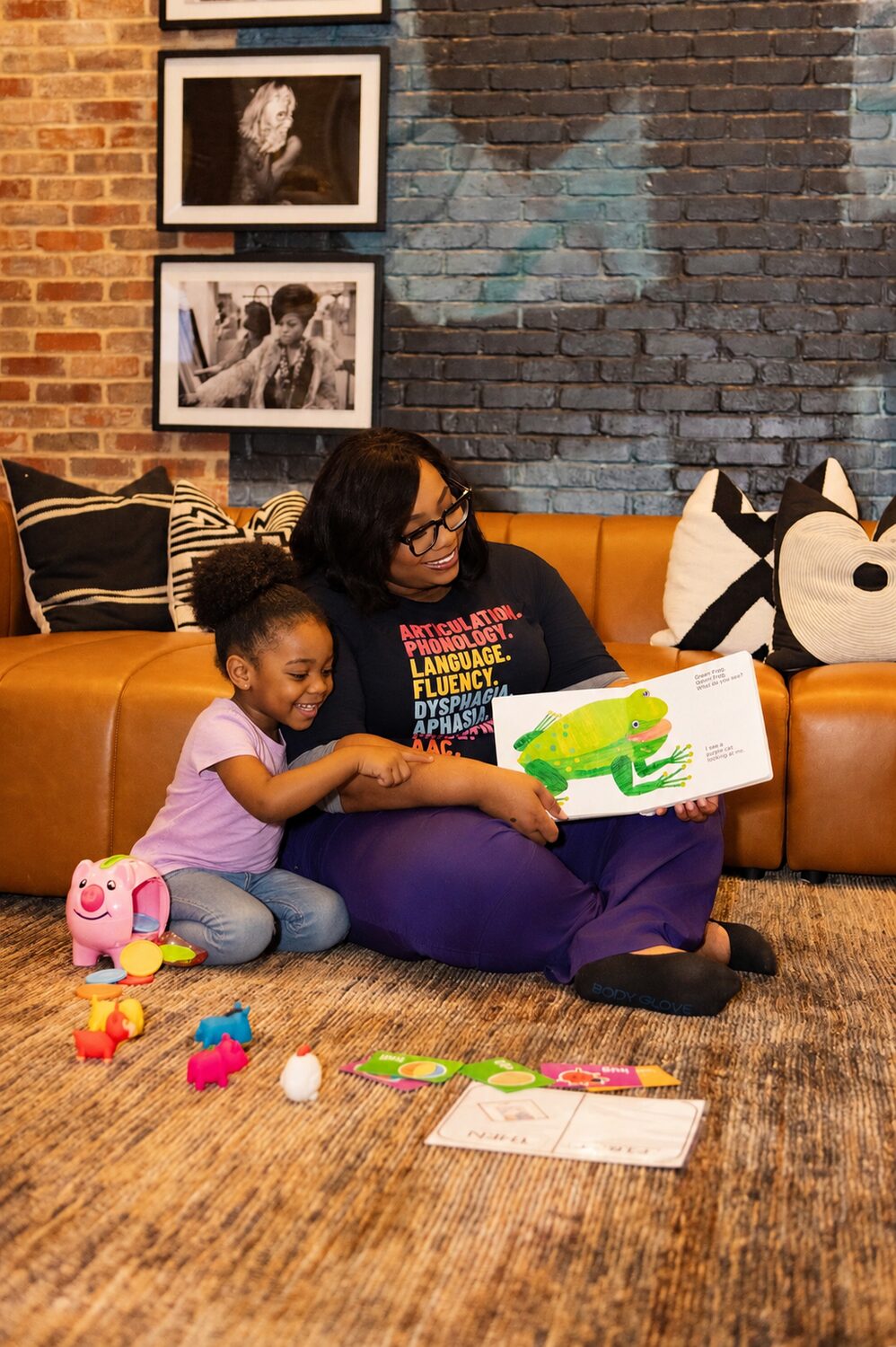 Olivia reading a picture book with a child during a session